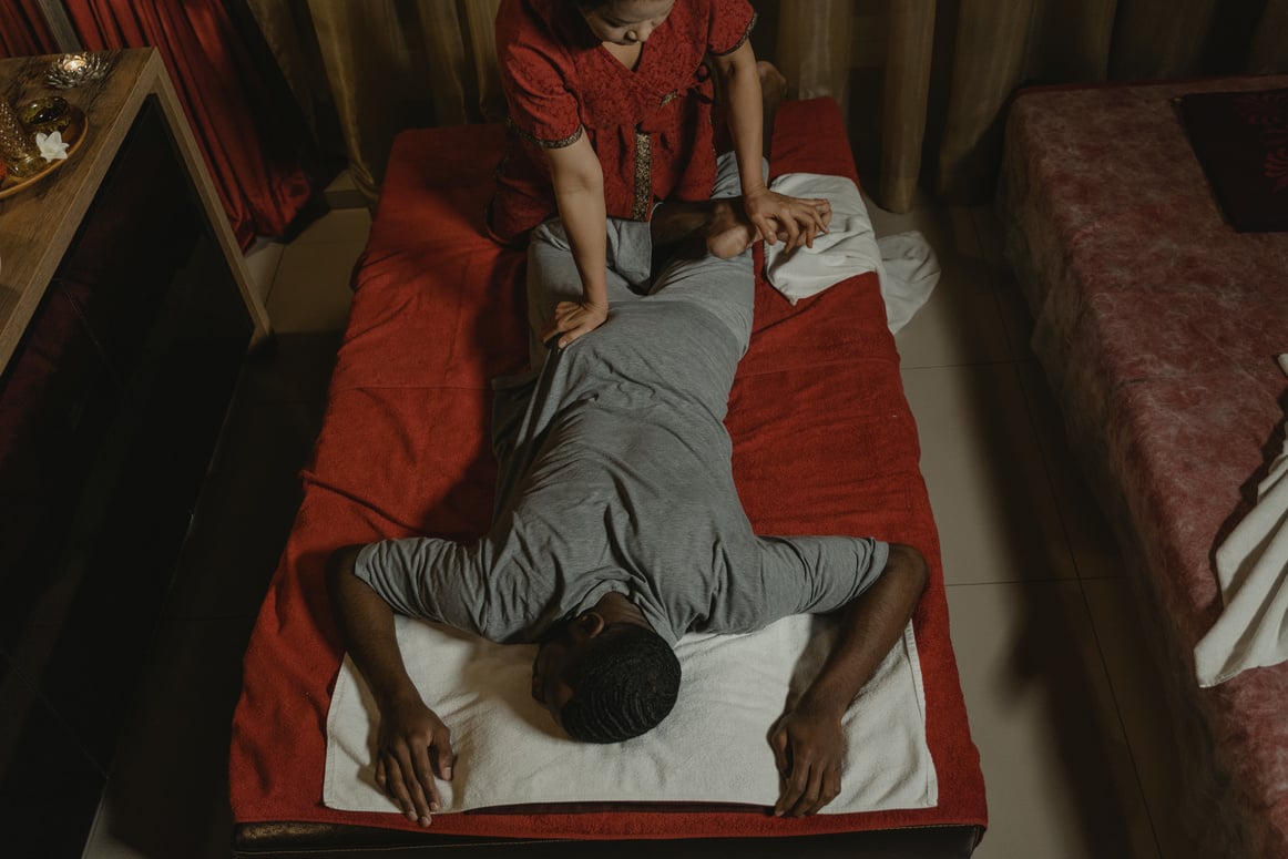 Woman in Red Shirt Making Thai Massage